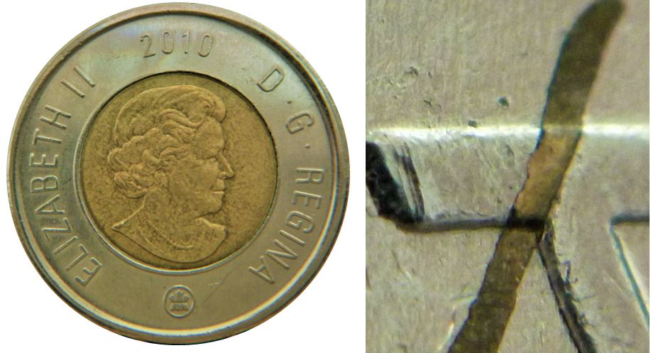 2 Dollars 2010-Résidu de métal encastré sur A de canadA-1.JPG