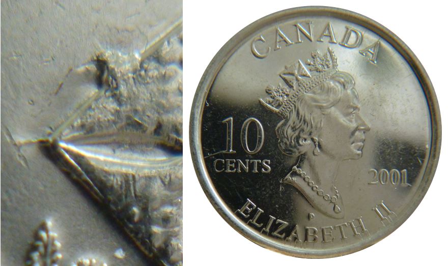 10 Cents 2001-Éclat coin sur la croix pattée de la couronne-1.JPG